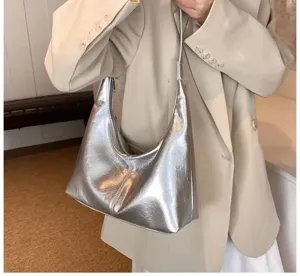 Silver metallic shoulder underarm bag detail view showing soft leather texture and stylish shape.