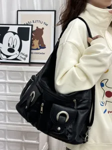 Black PU leather casual shoulder bag with multiple pockets, metal ring buckles and zippers.