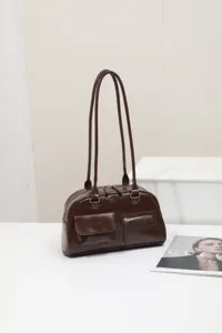 Detail view of the dark brown women's shoulder underarm bag with double slim straps.
