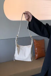 Korean vintage white shoulder underarm bag detail showing side zipper and metal buckle.
