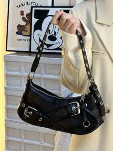 Black leatherette underarm motorcycle shoulder bag with metal buckles and studs.