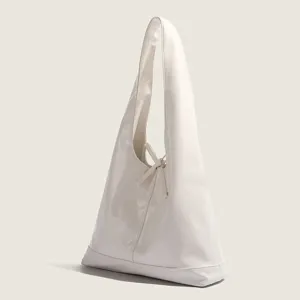 White soft leather hobo shoulder bag with elegant bow detail, stylish large capacity commute tote.