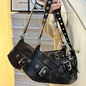 Detailed view of punk style motorcycle shoulder bag with metal buckles and grommet straps.
