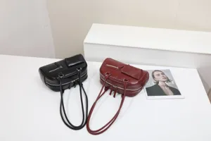 Detailed view of minimalist PU leather shoulder bags in black and red with metal zippers.