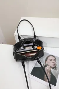 Black patent leather shoulder bag detail, large capacity underarm boston bag with zipper.