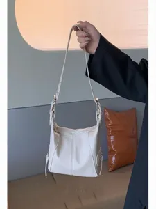 White leather shoulder bag for women, retro underarm hobo bag with zipper and buckle details.