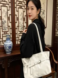 Korean style white patent leather shoulder bag, versatile motorcycle style tote for women.