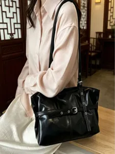 Black leather shoulder tote bag for women, large capacity commuter casual motorcycle style handbag.