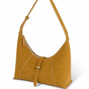 Vintage brown suede hobo shoulder bag with contrast stitching and front metal ring detail.