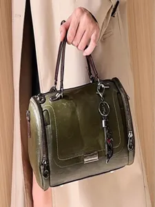 Vintage green leather Boston shoulder bag for women, stylish crossbody handbag for autumn.