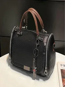 Stylish black Boston handbag with brown top handles, side zippers and metal charms.