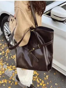 Stylish large brown tote shoulder bag for women, ideal for autumn daily commute style.