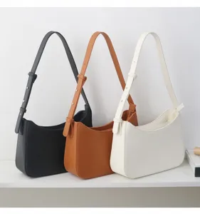 Detailed view of fashionable underarm shoulder bags in three classic colors for daily use.