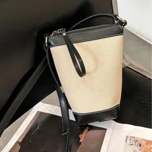Canvas bucket bag for women, stylish contrast leather trim crossbody shoulder bag.