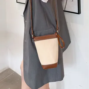 Canvas bucket crossbody bag for women, stylish casual shoulder bag with leather trim daily use.
