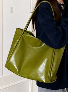 Detailed close-up view of the large green tote bag shoulder strap and PU leather texture.