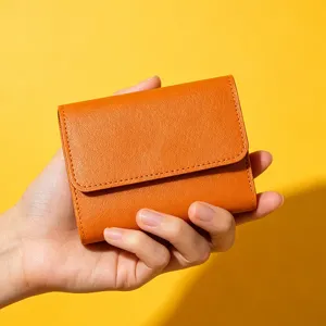 Minimalist orange short trifold women wallet detail, compact card holder and coin purse.