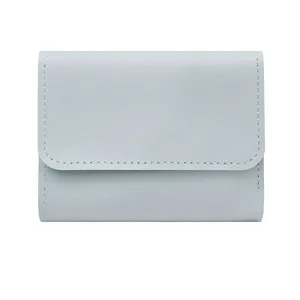 Light blue trifold wallet detail, compact card holder with fine stitching and smooth finish.