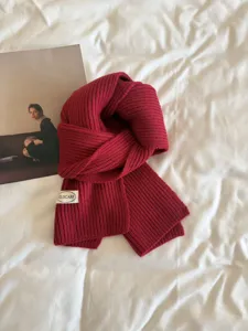 Cozy red knitted winter scarf, soft texture, classic solid color design for daily warmth.