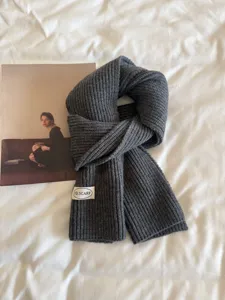 Dark grey knitted scarf for women, winter warm ribbed neck warmer, cozy minimalist style accessory.