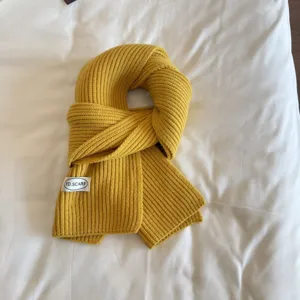 Solid color knitted scarf for winter warm neck protection, stylish casual design for women.