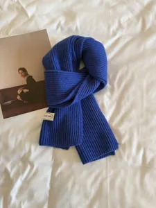 Blue knitted winter scarf for women, soft warm ribbed neck warmer fashion accessory.