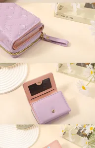 Detailed view of the women's short wallet with quilted heart pattern, card slots and zipper pocket.