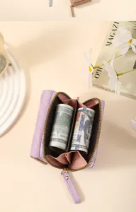 Close-up of the quilted short wallet interior showing multiple compartments and neatly rolled cash inside.