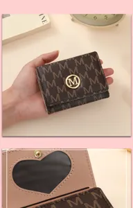 Close-up detail of the compact women trifold wallet, showing monogram leather and heart ID window.