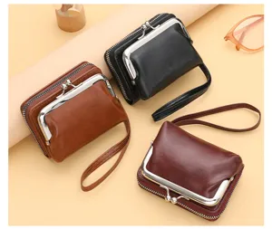 Close-up detail of retro women's kiss-lock coin purses with zippers and hand straps in three colors.