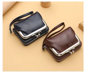 Vintage women's clutch coin purse with kiss lock clasp and zipper pocket, portable wrist strap.