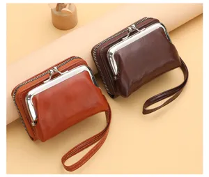 Detail view of vintage women leather kiss lock coin purse with zipper and wrist strap chic.