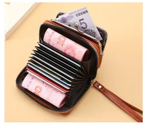 Detail shot of brown retro card wallet interior, showing multiple card slots and zipper pocket.