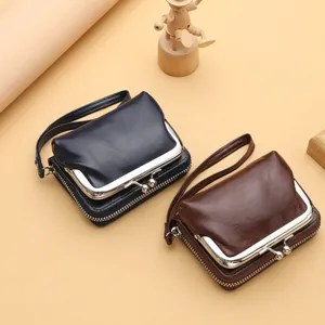 Women's retro kiss-lock coin purse clutch bag with zipper and wrist strap chic compact design.