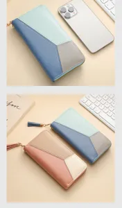 Close-up detail of color-blocked long wallet with zip-around closure and stylish tassel charm.