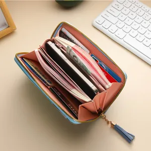 Color block long zipper wallet for women, large capacity clutch purse with tassel and multiple card slots.