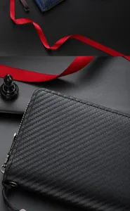 Close up view of black carbon fiber texture men long zip wallet detail shot for business style.