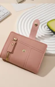 Pink short bifold wallet for women with zipper coin pocket, card slots and cute snap closure.