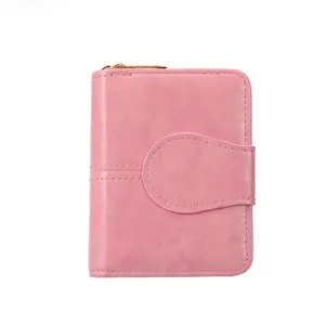 Women's pink short wallet with zipper and snap buckle, compact PU leather multi-card purse.