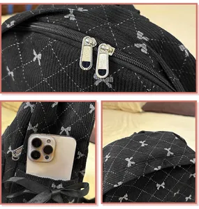Cute black quilted bow backpack for women and students, stylish casual daypack for travel.