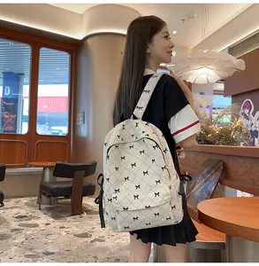 Cute corduroy backpack for women, stylish bowknot design, casual school bag for daily use.