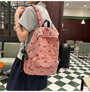 Pink corduroy backpack featuring a cute bow pattern, perfect for school, travel, and daily use.