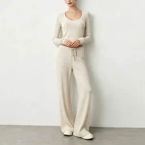 Ribbed knit yoga outfit with long sleeve scoop neck top and wide leg pants for women.