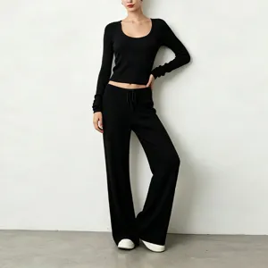 Black ribbed long sleeve top and wide leg pants detail showing soft fabric and comfortable fit.