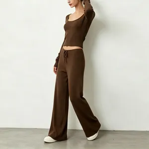 Ribbed knit yoga set with scoop neck long sleeve crop top and wide leg pants for women.