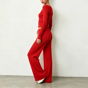 Red ribbed knit two-piece lounge set featuring a stylish slim long-sleeve top and wide-leg pants.