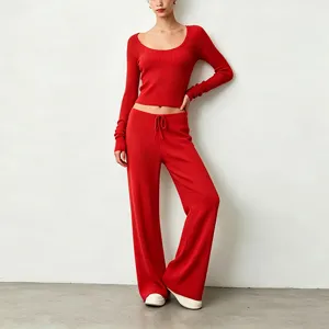Close up detail shot of red ribbed knit long sleeve crop top and wide leg pants.