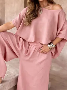 Close-up detail view of casual loose off-shoulder summer top and matching pants set.