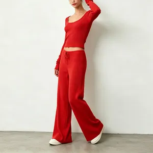 Red ribbed knitted long-sleeve crop top and wide-leg pants set, soft and comfortable wear.