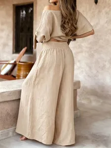 Close-up back view of summer casual off shoulder two piece set wide leg trousers beige.